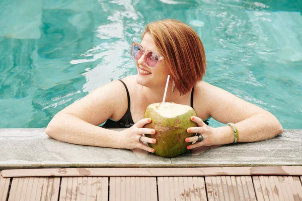 코코넛 칵테일을 수영장에 바라보고 — 스톡 사진