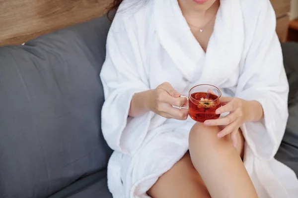 Cropped Image Woman Bathrobe Sitting Sofa Cup Tasty Herbal Tea — Stock Photo, Image