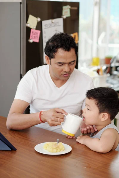 Father Giving His Little Son Cup Water Eating Breakfast Watching — Stockfoto