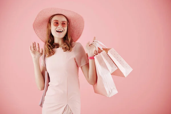 Portrait Excited Young Woman Hat Sunglasses Holding Shopping Bags Waving — Stock Photo, Image