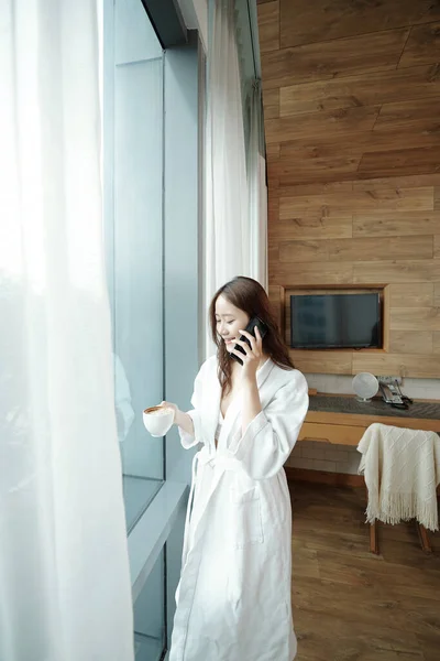Fürdőköpenyes nő beszél telefonon. — Stock Fotó