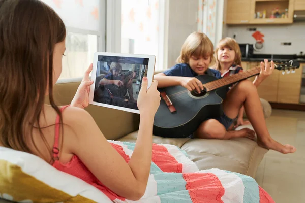 Girl Filming Brother Playing Guitar — Stock Photo, Image