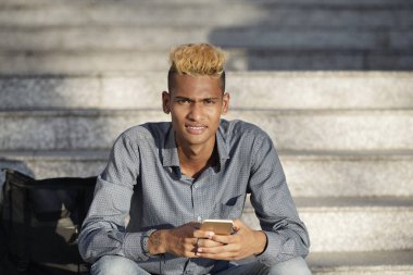 Çatık kaşlı, yakışıklı, şık genç adam.