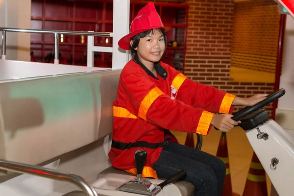 Girl wearing firefighter uniform — Stock Photo, Image