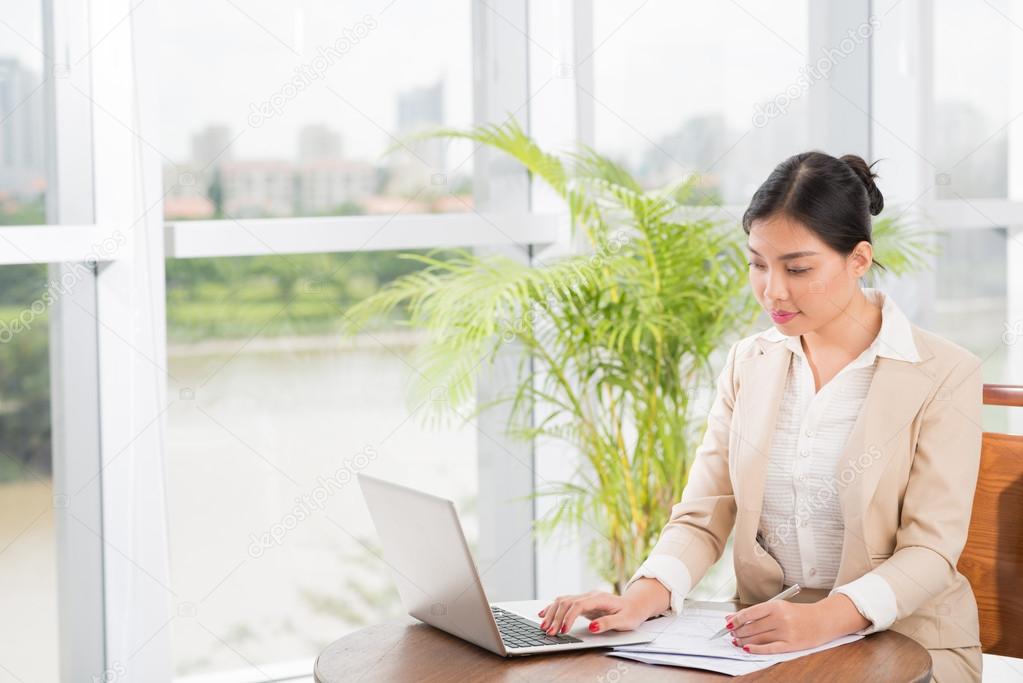 Vietnamese manager using laptop