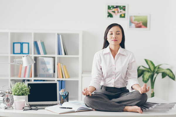 Female office worker meditating