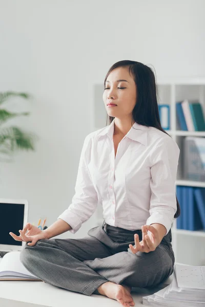 Meditating in the office — Stock Photo, Image