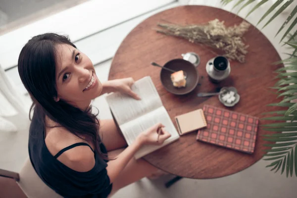 Woman  writing in the exercise book