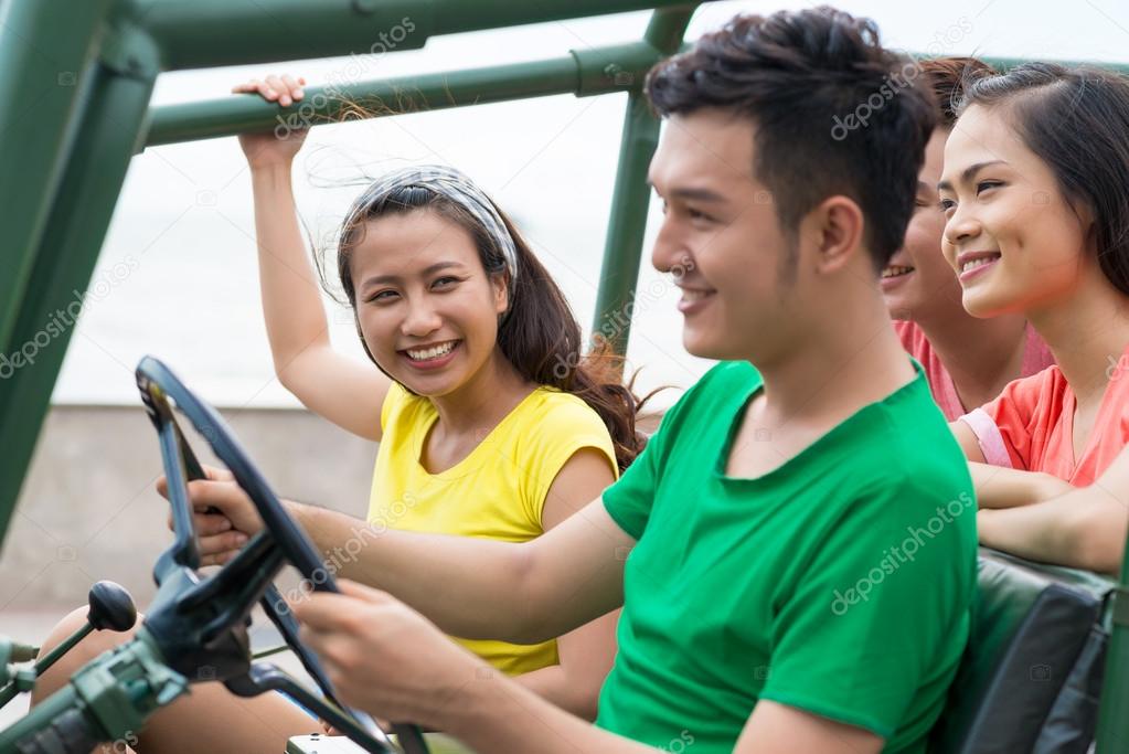 Vietnamese friends travelling by off-road vehicle