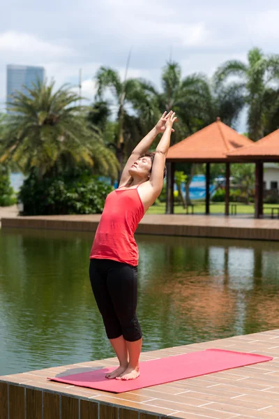 Aged woman doing asana — Stock Photo, Image