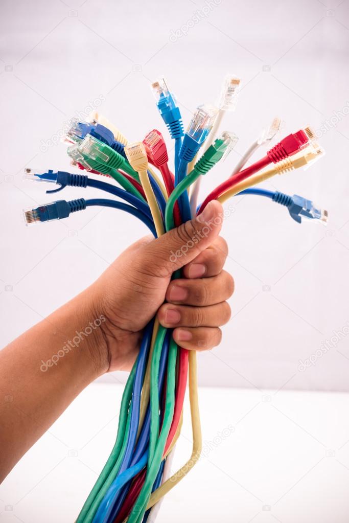 Hand holding coloured internet cables