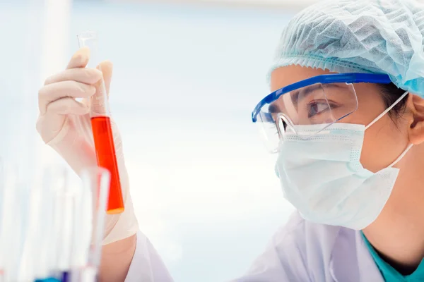 Medical researcher looking at test tube — Stock Photo, Image