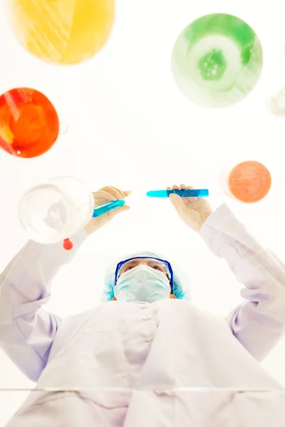 Chemist working at transparent table — Stock Photo, Image