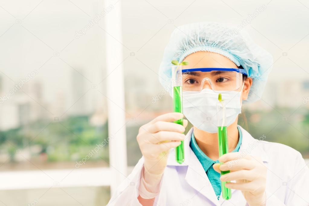 Laboratory worker holding test tubes