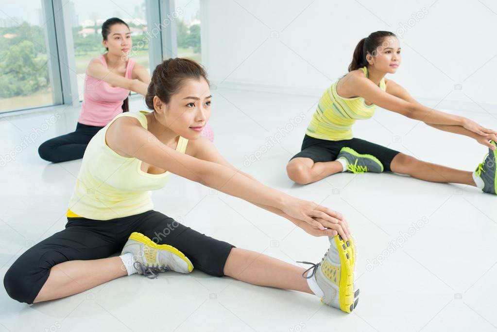 Young women doing stretching exercise