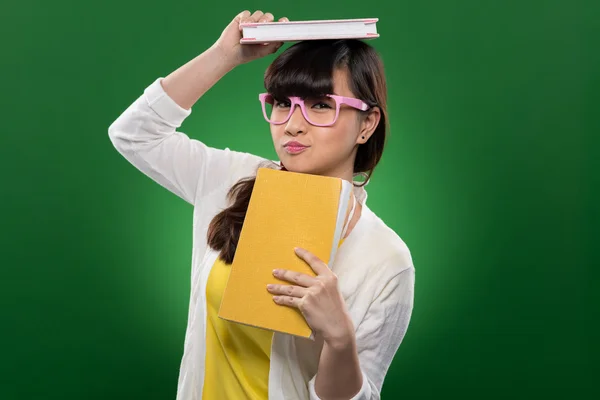 Menina engraçada com livros — Fotografia de Stock