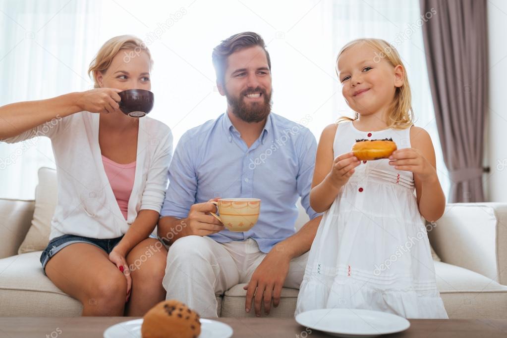 Family having tea with doughnuts