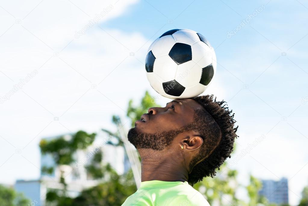 Player balancing soccer ball