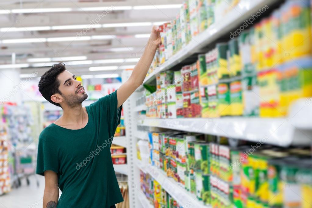 Young customer taking canned food