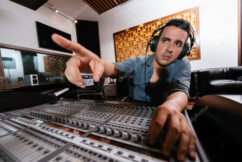 Sound engineer in headphones pointing — Stock Photo © DragonImages