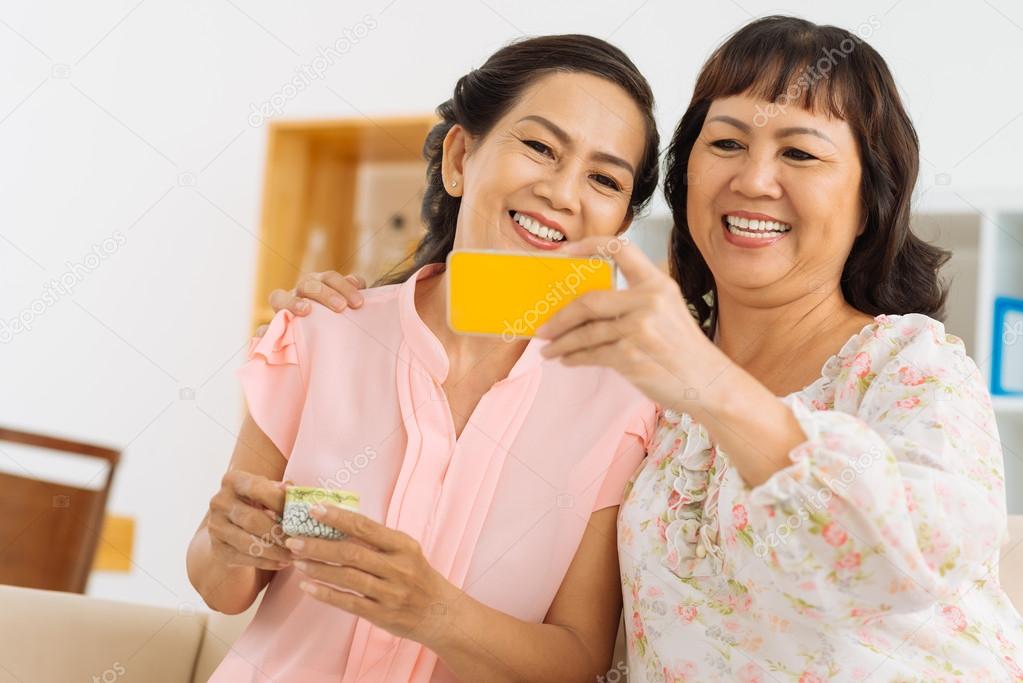 Female friends taking selfie