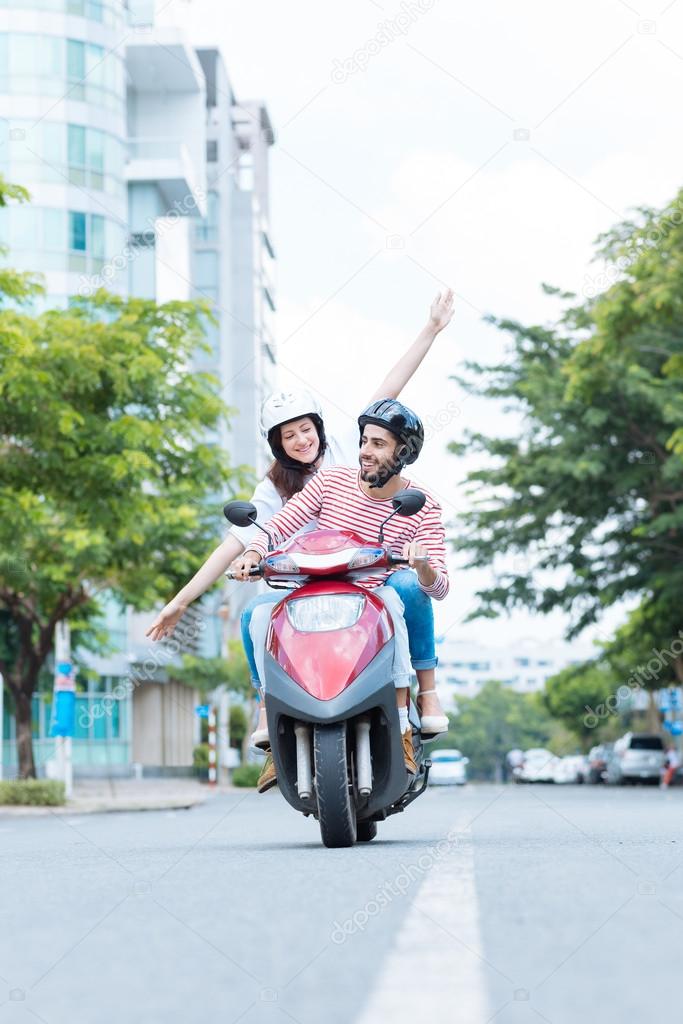 Couple riding a motor scooter
