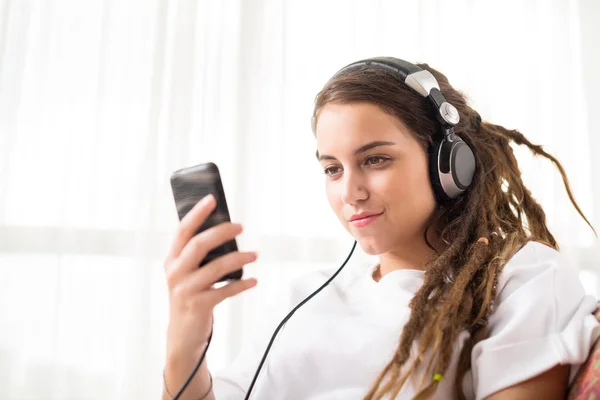 Ragazza in cuffie messaggio di testo — Foto Stock