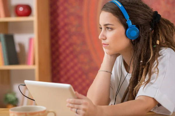 Pensive girl with digital tablet — Stock Photo, Image