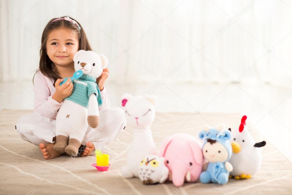 Girl with knitted toys