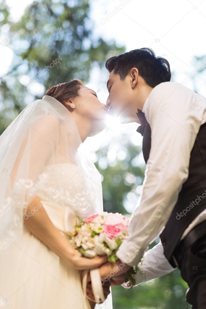 Kissing wedding couple