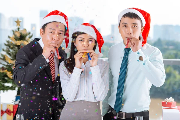 Coworkers with party blowers — Stock Photo, Image