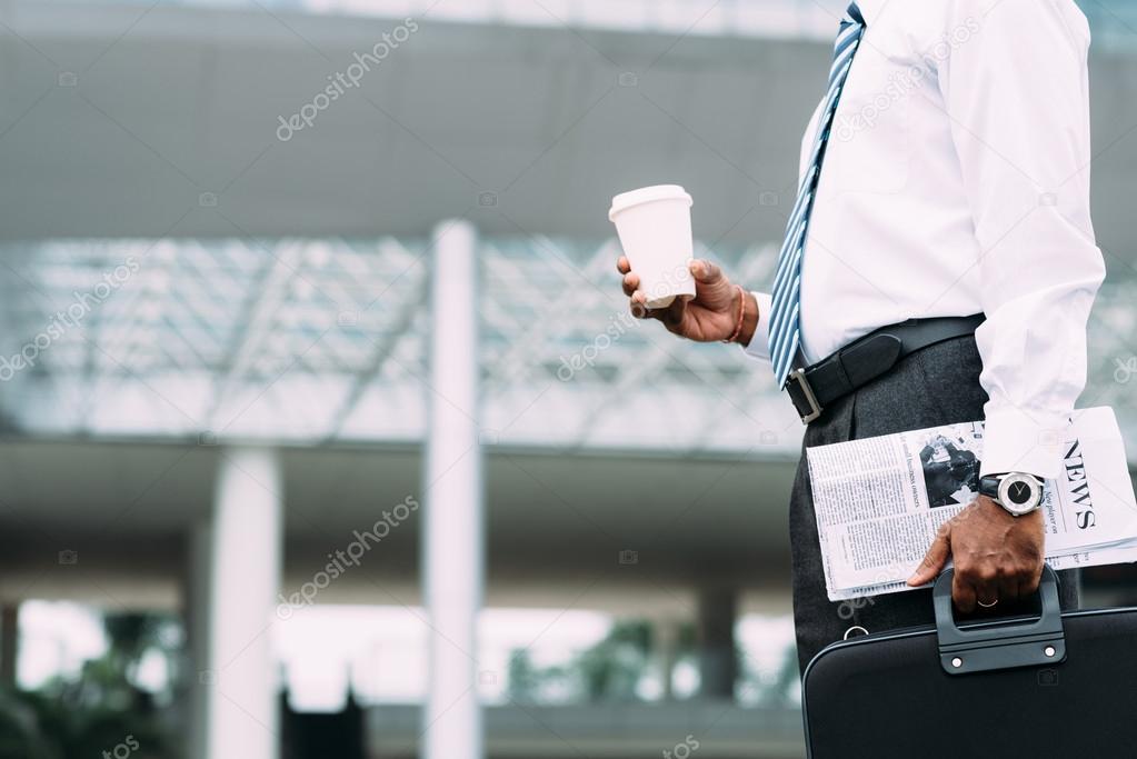 Businessman with coffee and newspaper