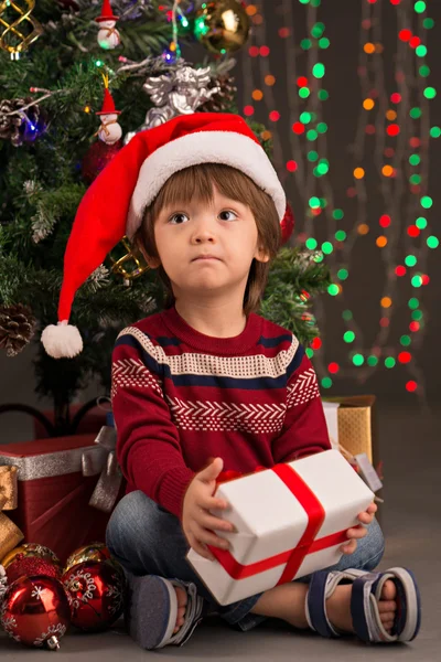 Cute boy with Christmas present — Stock Photo, Image