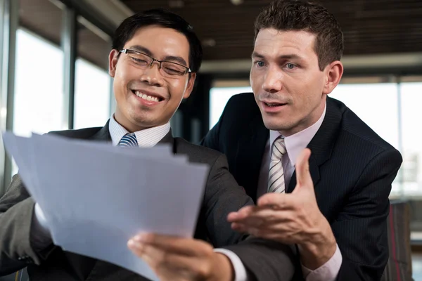 Colleagues reading report — Stock Photo, Image