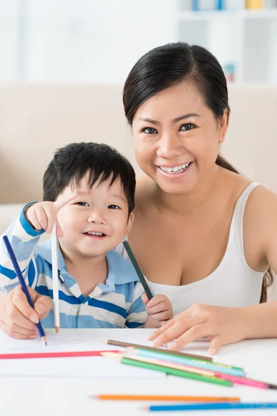 Mother and son drawing together