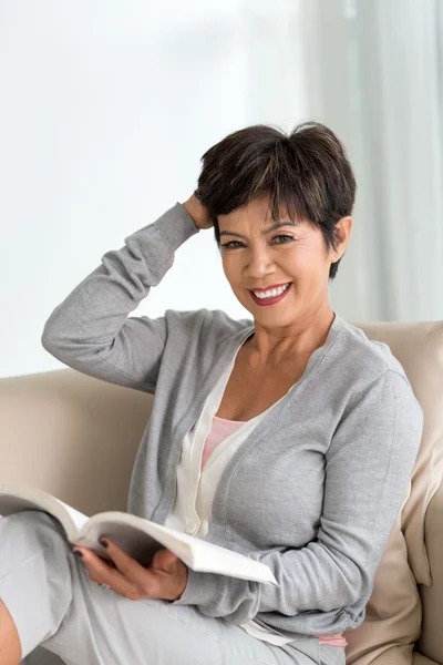 Attractive mature woman with a book — Stock Photo, Image