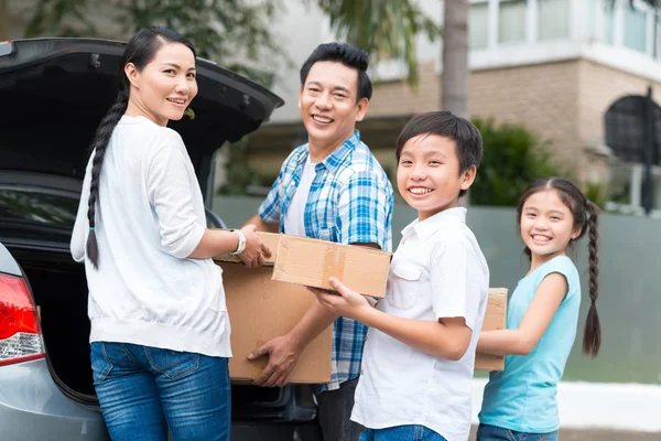 Family with cardboard boxes