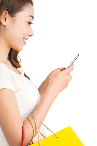 Woman with paper bags using smartphone — Stock Photo, Image