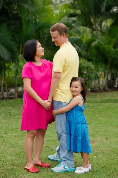 Loving mixed-race family in the park — Stock Photo, Image