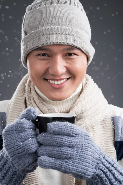 Человек в зимней одежде с чашкой чая — стоковое фото