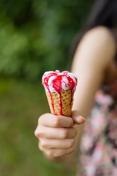 Girl holding melting strawberry ice-cream — Stock Photo, Image