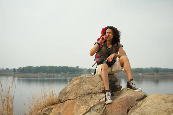 Hiker Having snack on a mountain