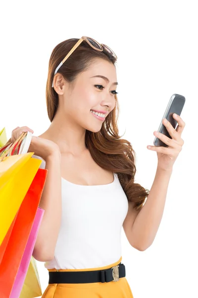 Lady with paper bags texting Royalty Free Stock Images