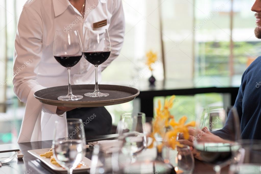 Waiter serving drinks in a restaura