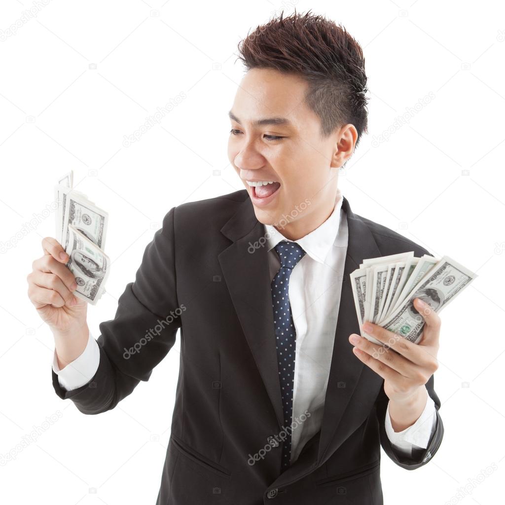 Businessman looking at money in hands
