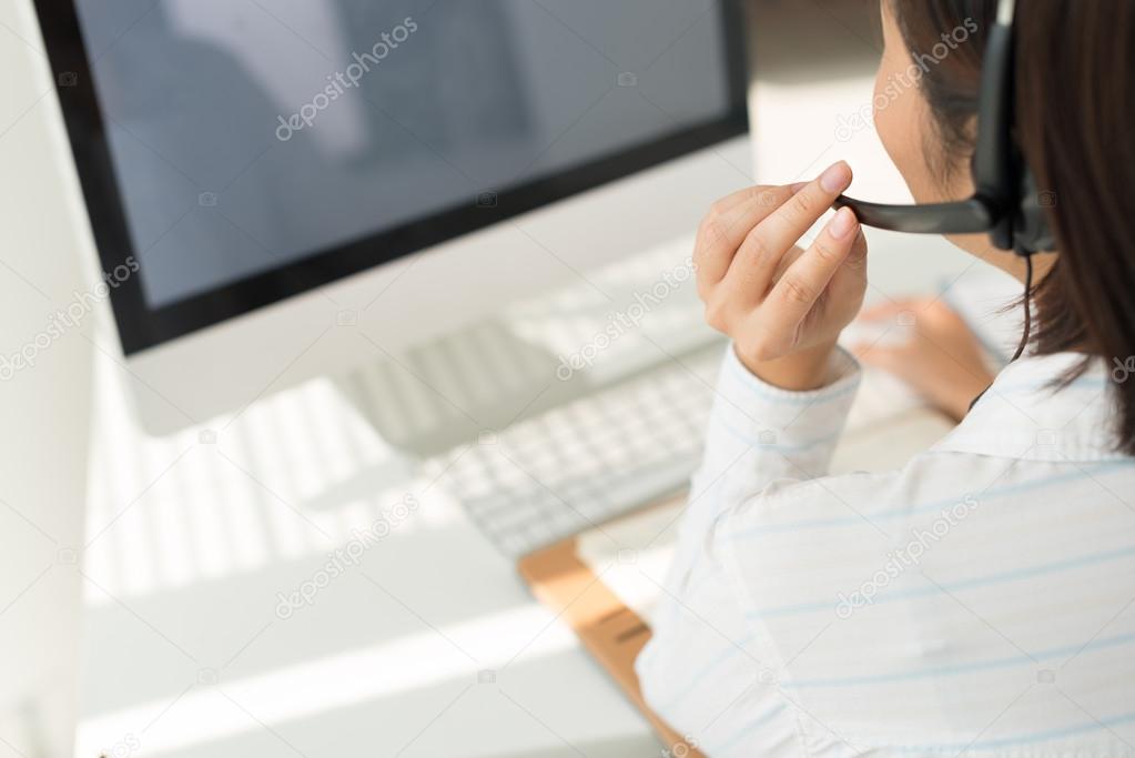 Woman with headset working on computer