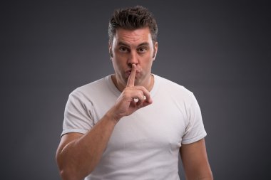 sessizlik hareketi gösteren adam