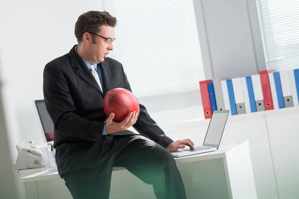 Businessman betting on football — Stock Photo, Image