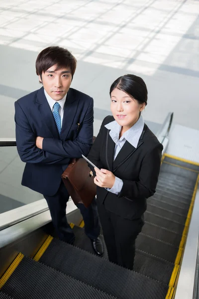Business team on the escalator — Stock Photo, Image