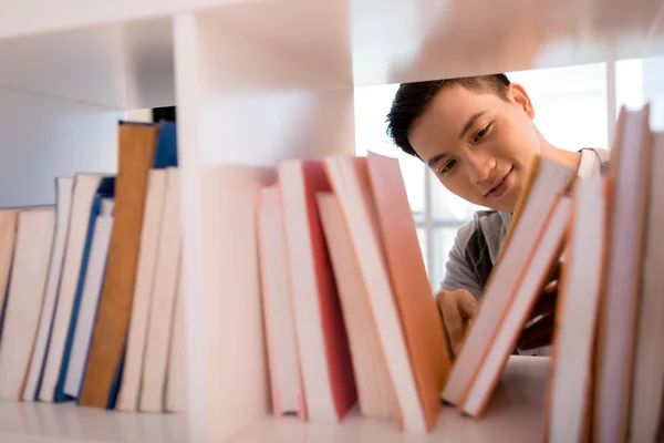 Étudiant choisissant livre — Photo